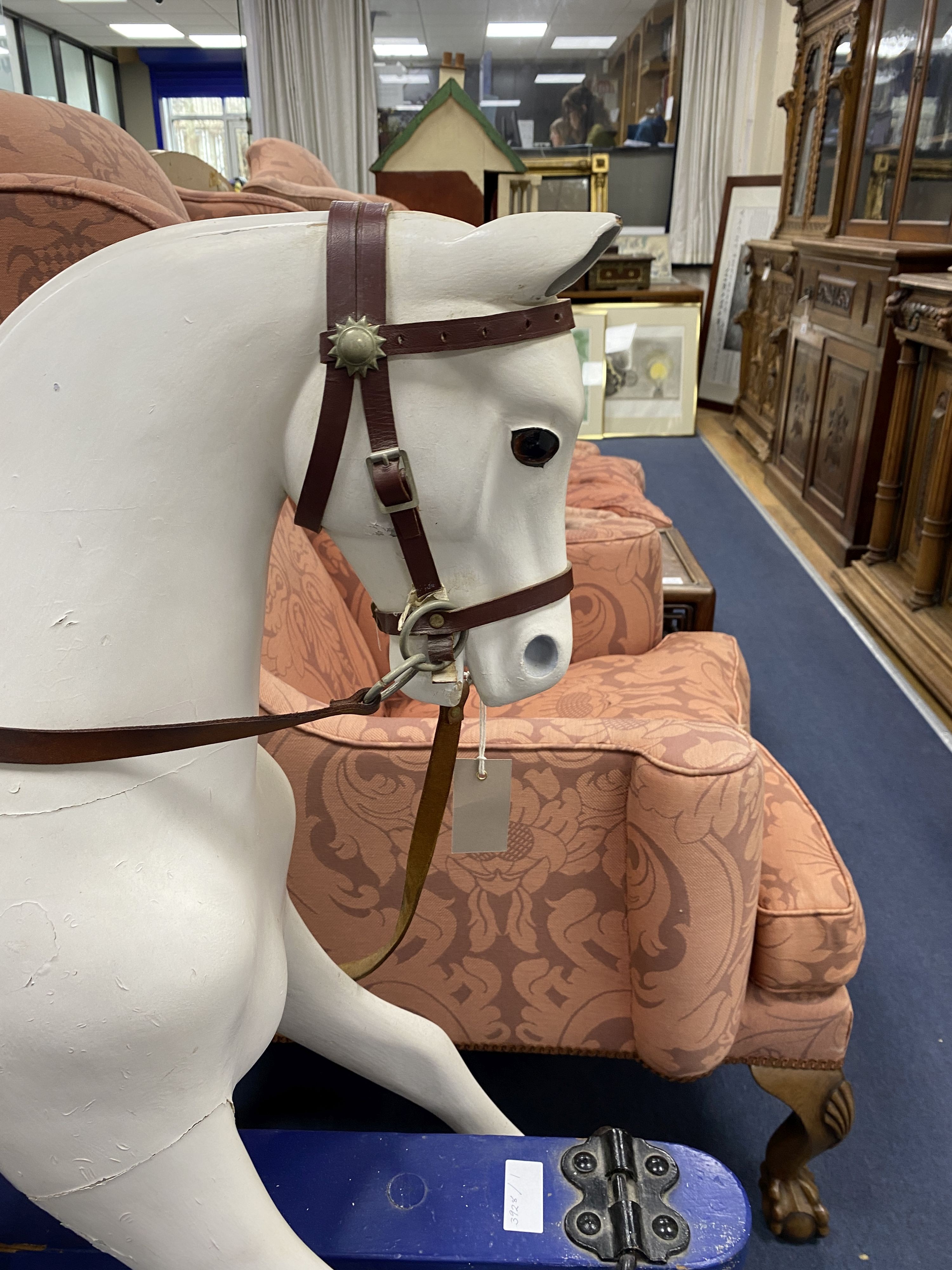 An early 20th century rocking horse on painted safety frame, (re-painted) width 126cm, height 114cm